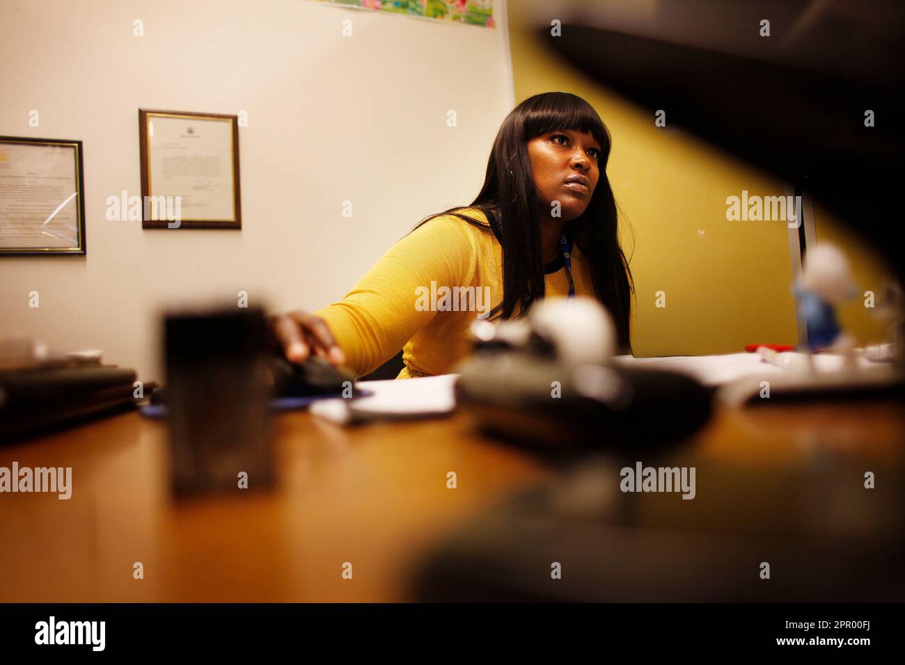 Camille Robinson, deputy probation officer in the Domestic Violence unit  and permanent backup Domestic Violence court officer files inputs  information into the computer from the mornings court calendar at the Hall  of