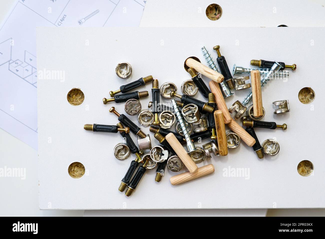 New white laminated chipboard furniture self mounting set with fitting screws, wooden pins