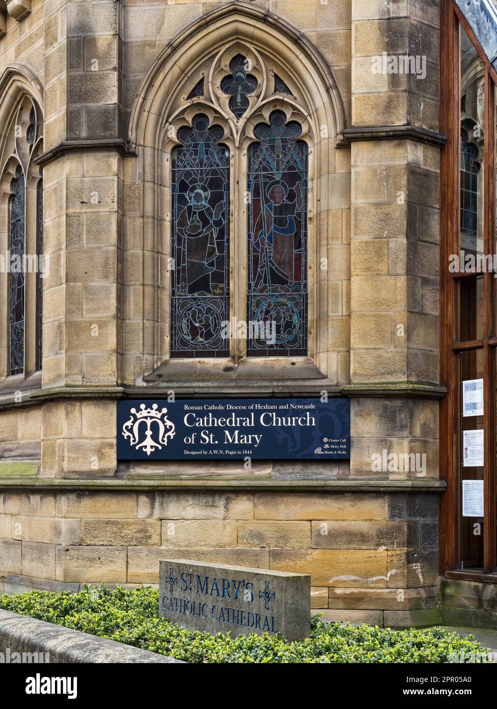 Signs and stained glass window beside the entrance to St Mary's Catholic Cathedral in Newcastle