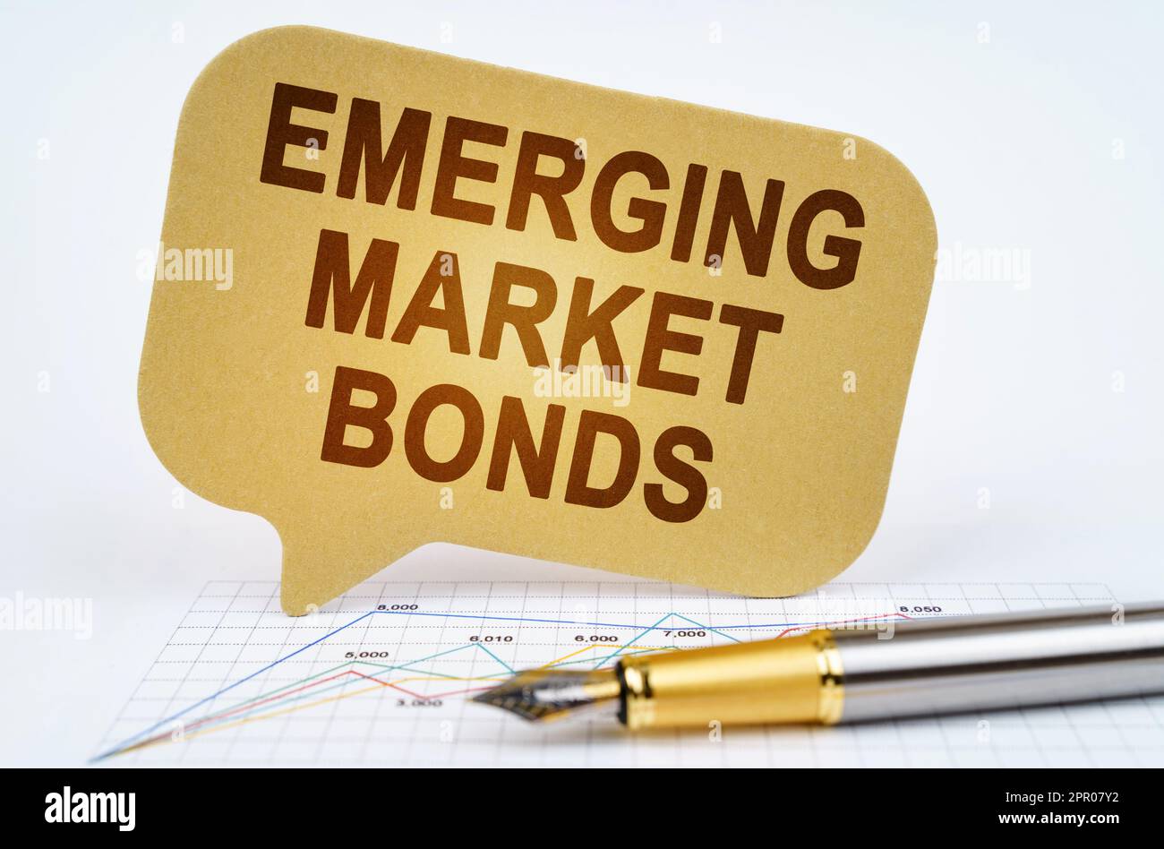 Business concept. On the business diagram is a pen and a sign with the inscription - emerging market bonds Stock Photo