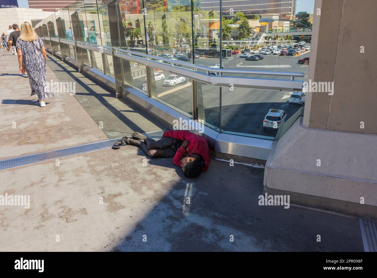 Close Up View Of Homeless Man Sleeping On Bridge Over Las Vegas Strip