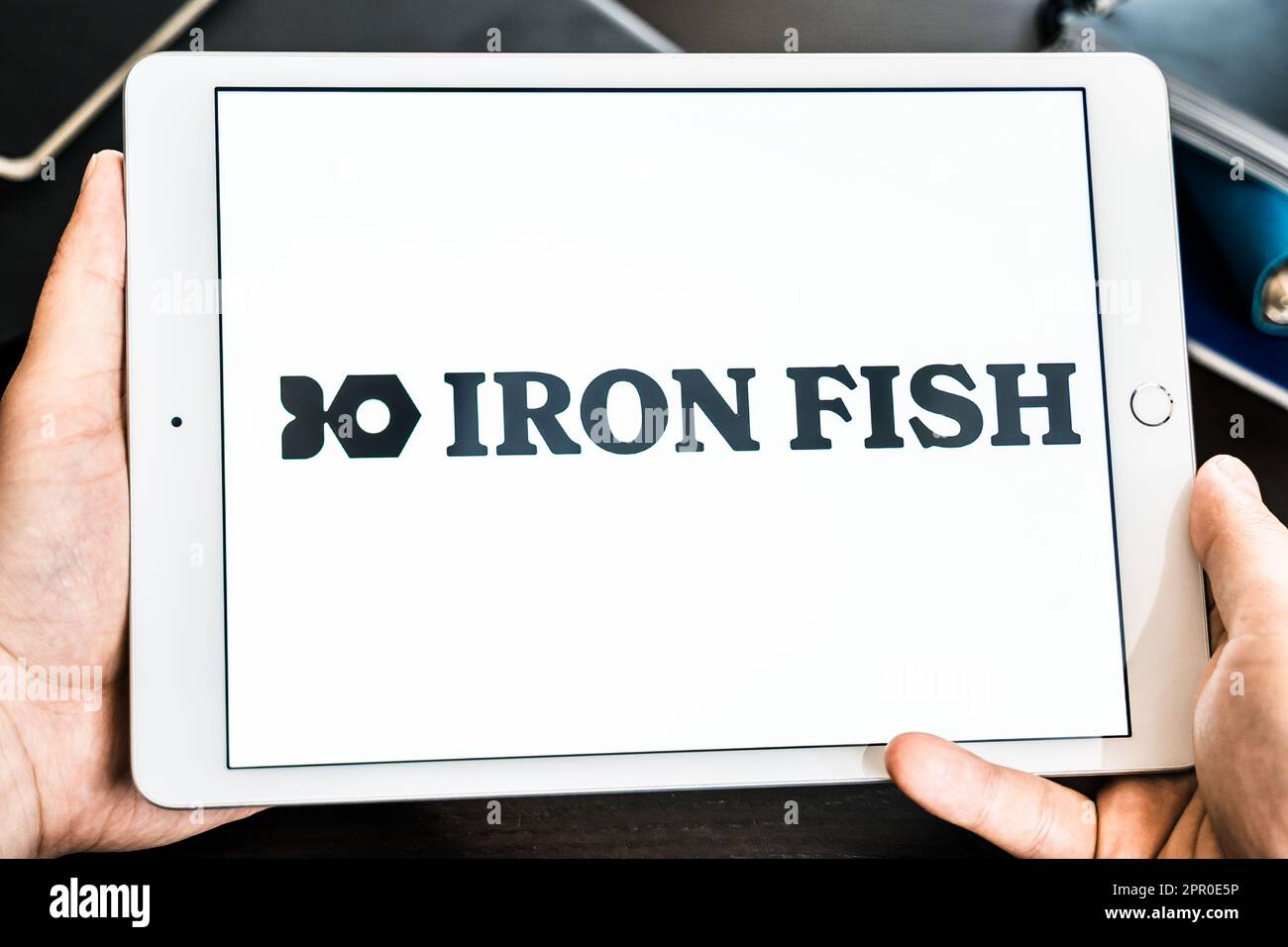 Russia Moscow 25.04.23 Logo of Iron Fish mining coin in tablen screen