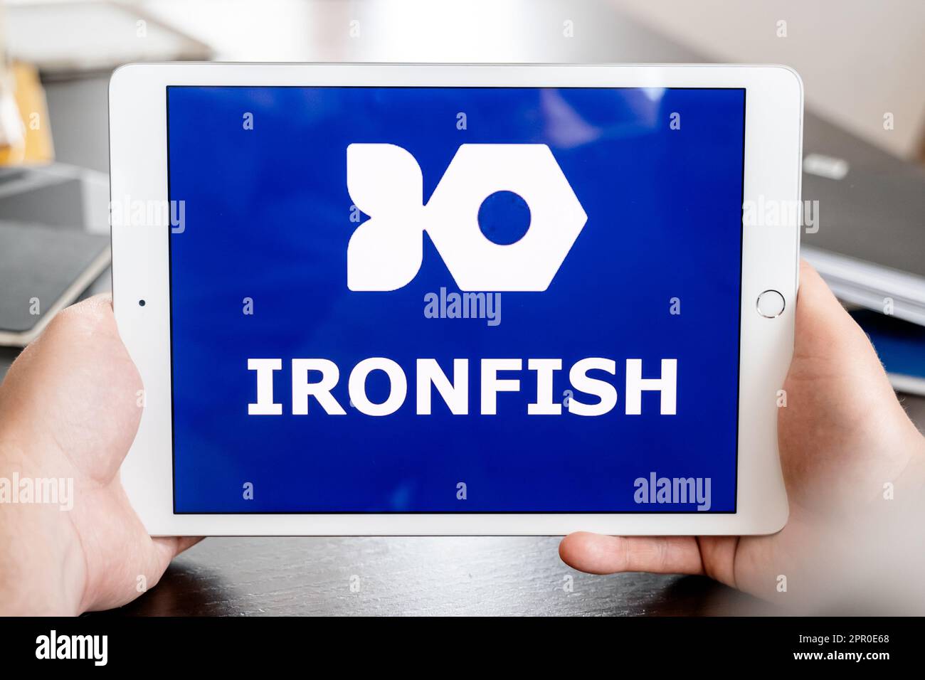 Russia Moscow 25.04.23 Logo of Iron Fish mining coin in tablen screen