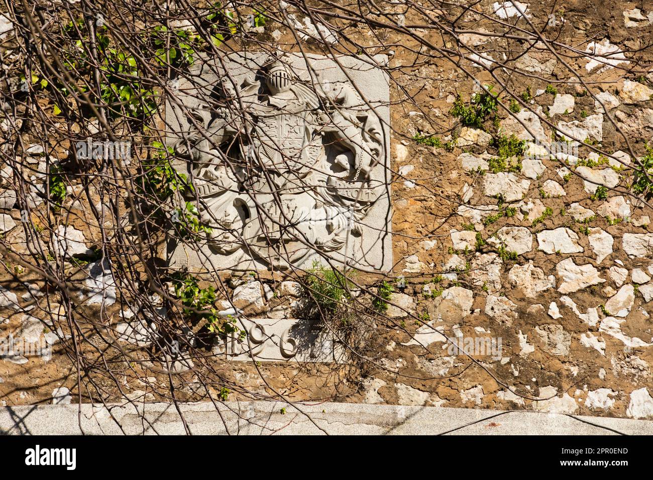 Overgrown coat of arms on the Southport gate, part of the curtain line wall defence around Gibraltar. The British Overseas Territory of Gibraltar, the Stock Photo