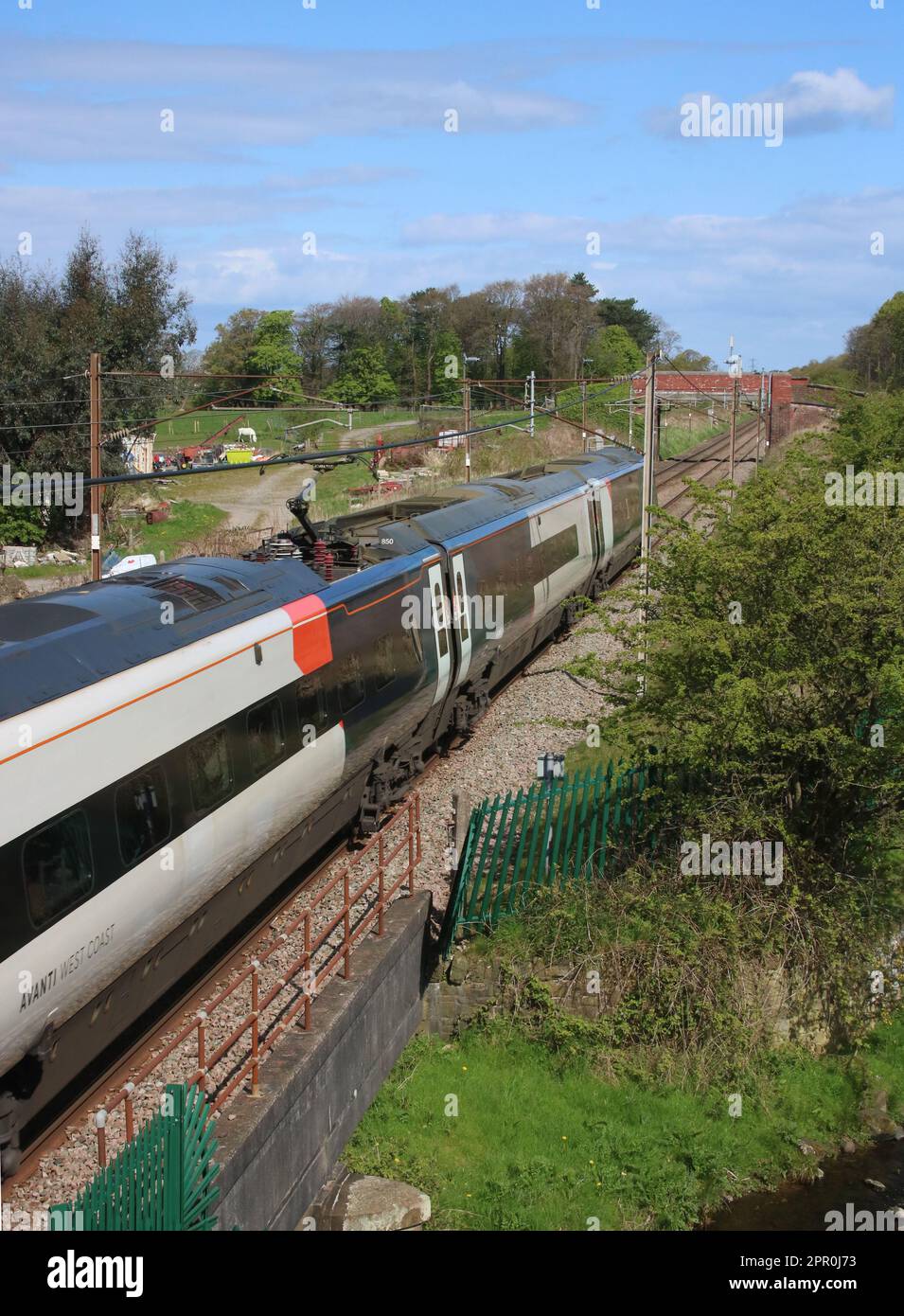 Avanti West Coast class 390 pendolino electric multiple-unit, number 390050, on the West Coast Main Line passing Woodacre near Garstang in Lancashire. Stock Photo