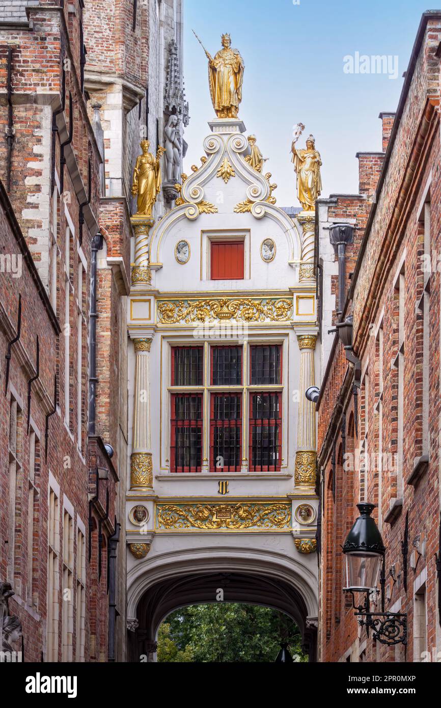 Ornamental connection bridge between City Hall and Brugse Vrije building crossing the alley Blinde-Ezelstraat in historic center of Bruges, Belgium Stock Photo