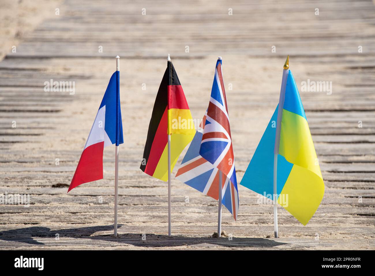 Flags of Germany and France and Great Britain and Ukraine on the sand in Ukraine on the shore, flags of countries Stock Photo