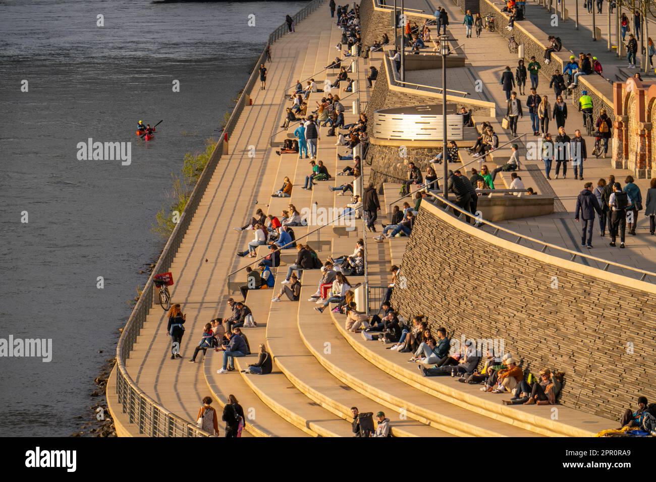 Rhine promenade, Rhine boulevard, on the Deutz bank, people sitting in the spring sun on the Rhine, Cologne NRW, Germany, Stock Photo