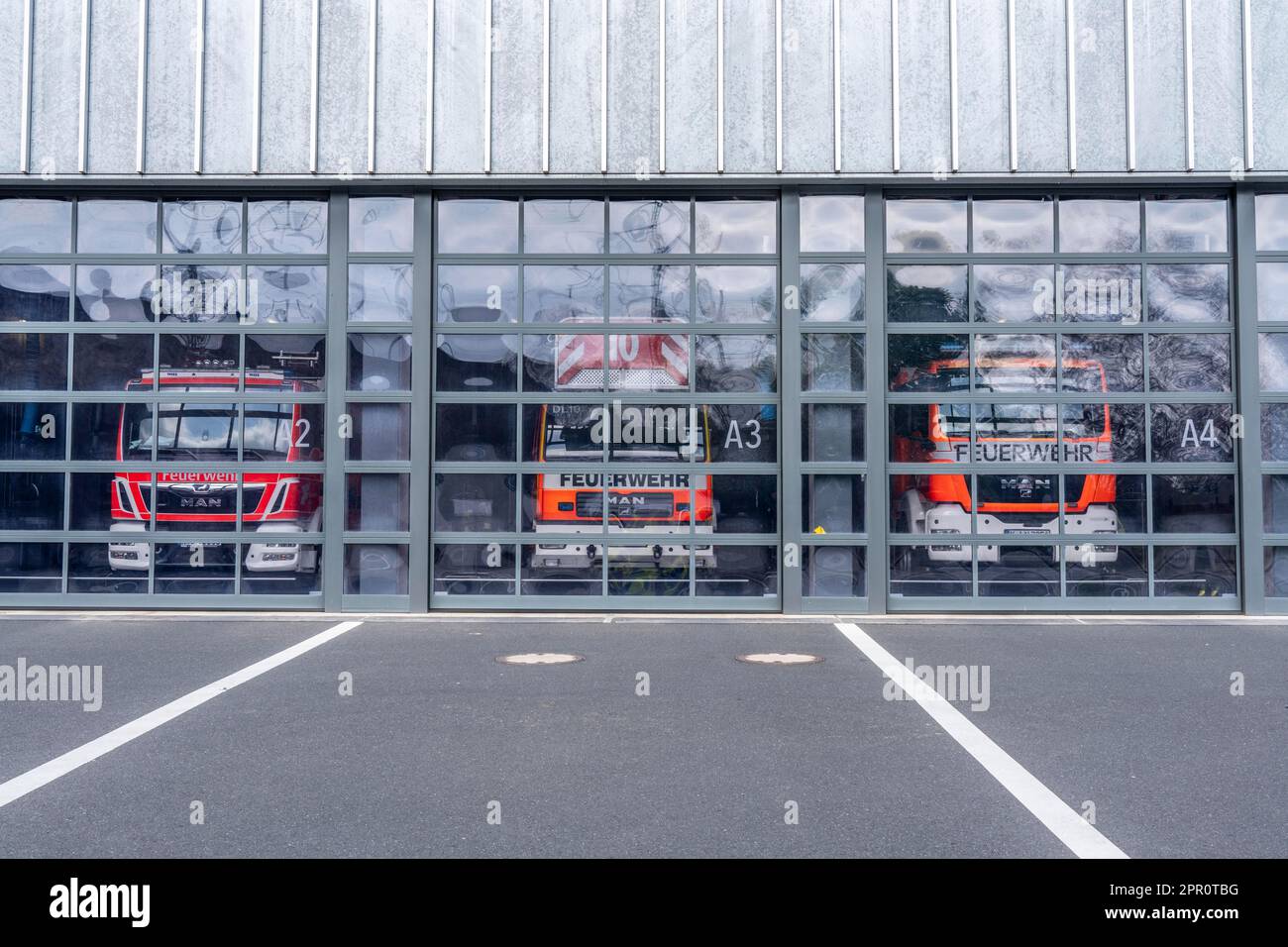 Fire brigade, fire station, modern station, glass gates, emergency vehicles standing in the vehicle hall, Cologne, NRW, Germany, Stock Photo