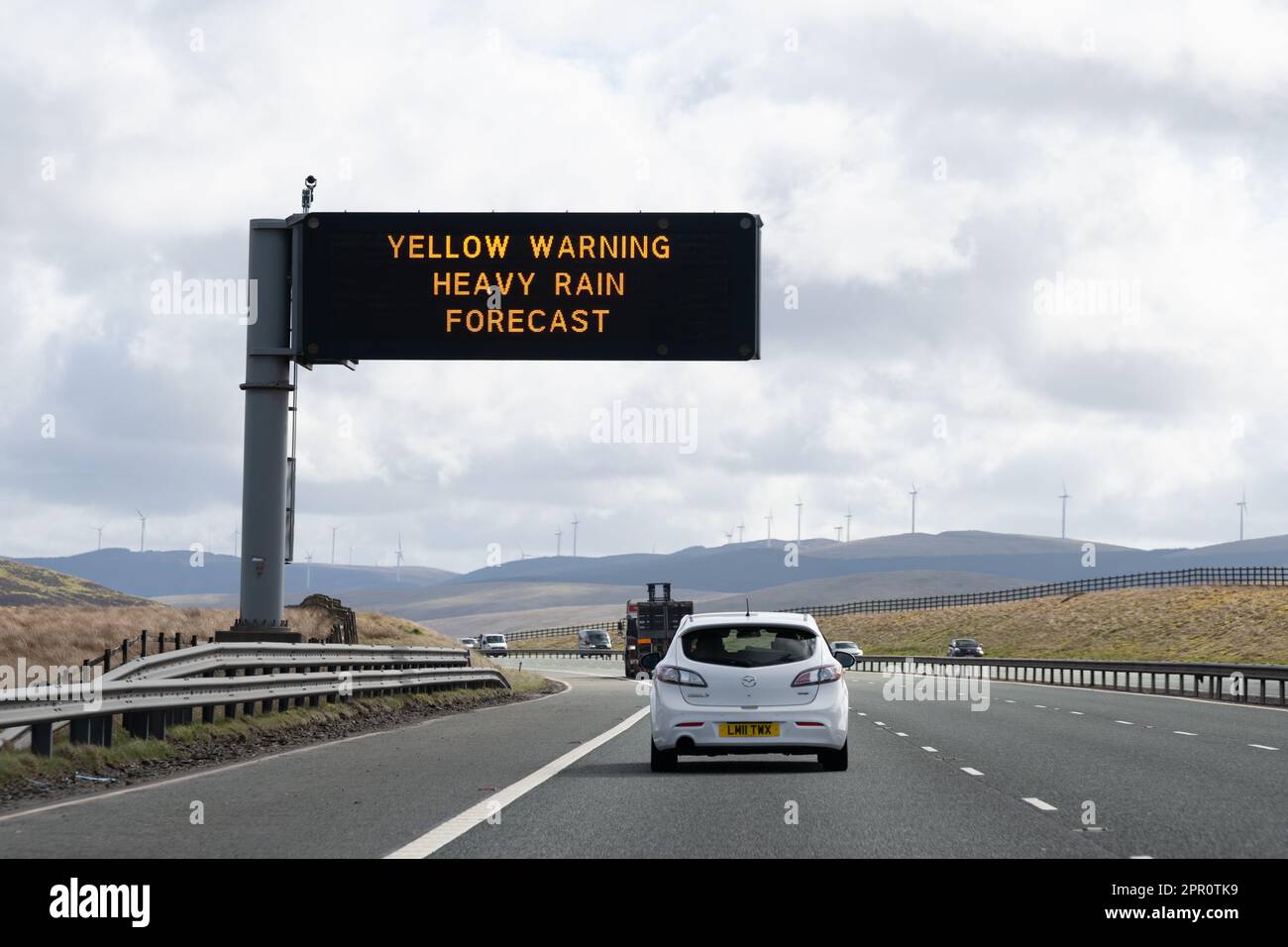 Yellow Warning Heavy Rain Forecast motorway sign on UK motorway Stock