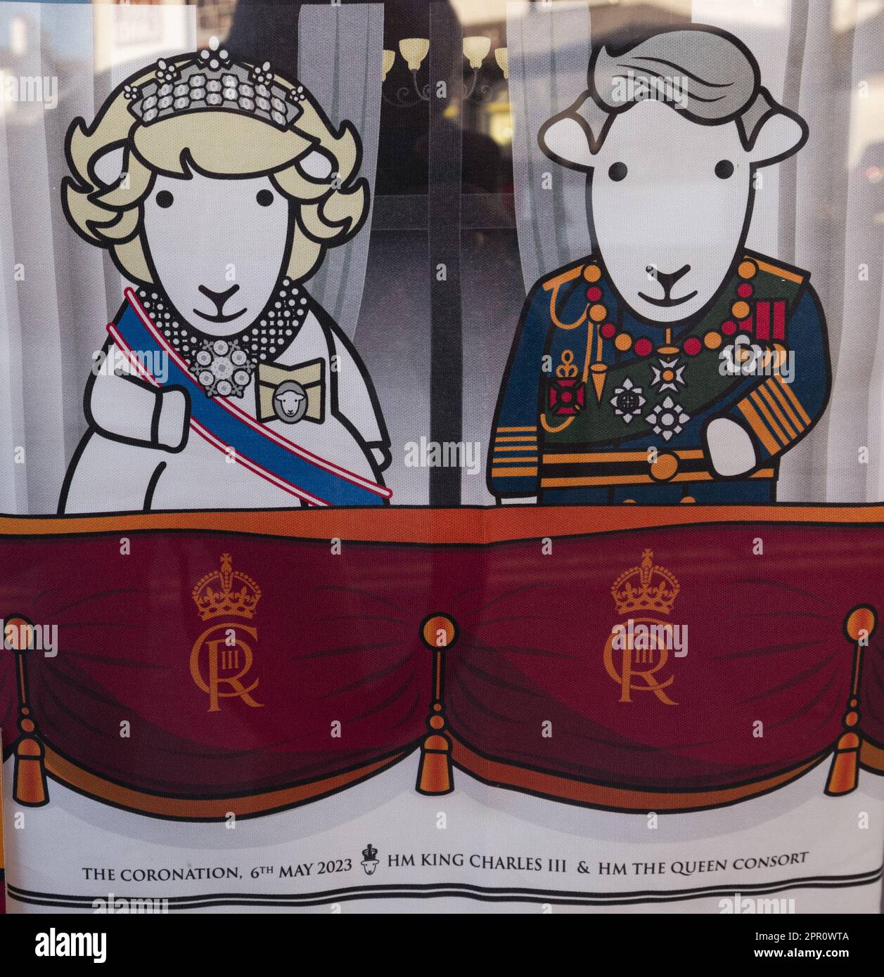 Bowness on Windermere Village Cumbria, UK. 25th Apr, 2023. humorous .window display for the Coronation HM King Charles III & HM The Queen Consort depicted as Herdwick Sheep (Herdwick sheep are the native breed of The Lake District ) Cumbria UK Credit: Gordon Shoosmith/Alamy Live News Stock Photo