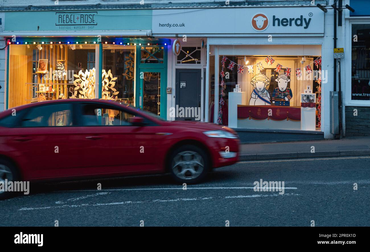 Bowness on Windermere Village Cumbria, UK. 25th Apr, 2023. humorous .window display for the Coronation HM King Charles III & HM The Queen Consort depicted as Herdwick Sheep (Herdwick sheep are the native breed of The Lake District ) Cumbria UK Credit: Gordon Shoosmith/Alamy Live News Stock Photo