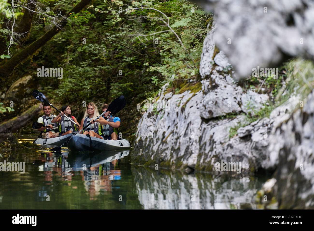 A young couple enjoying an idyllic kayak ride in the middle of a ...