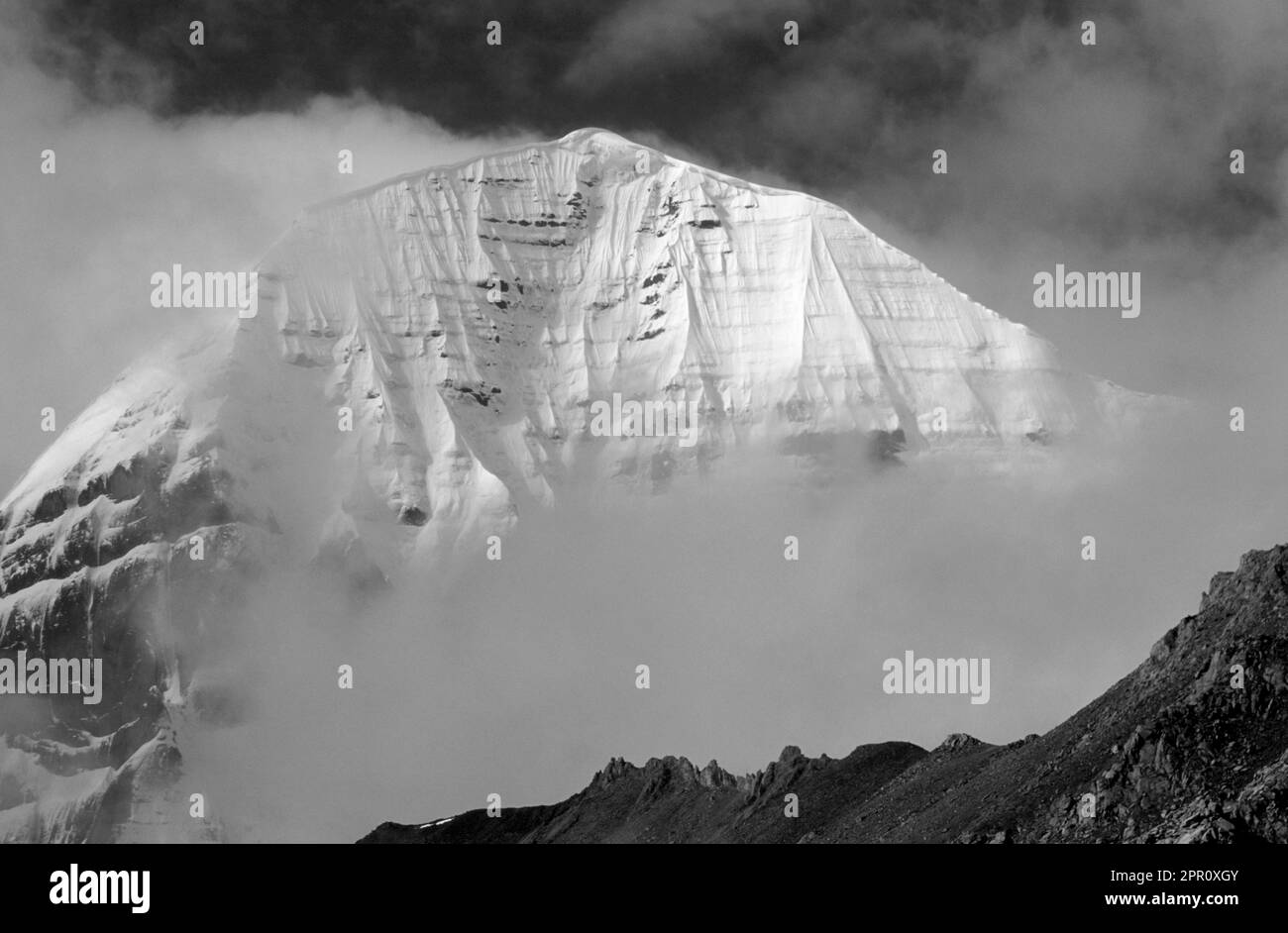 The mist enshrouded North Face of MOUNT KAILASH (6638 M) is a sacred site for BUDDHIST & HINDU  PILGRIMS - TIBET Stock Photo