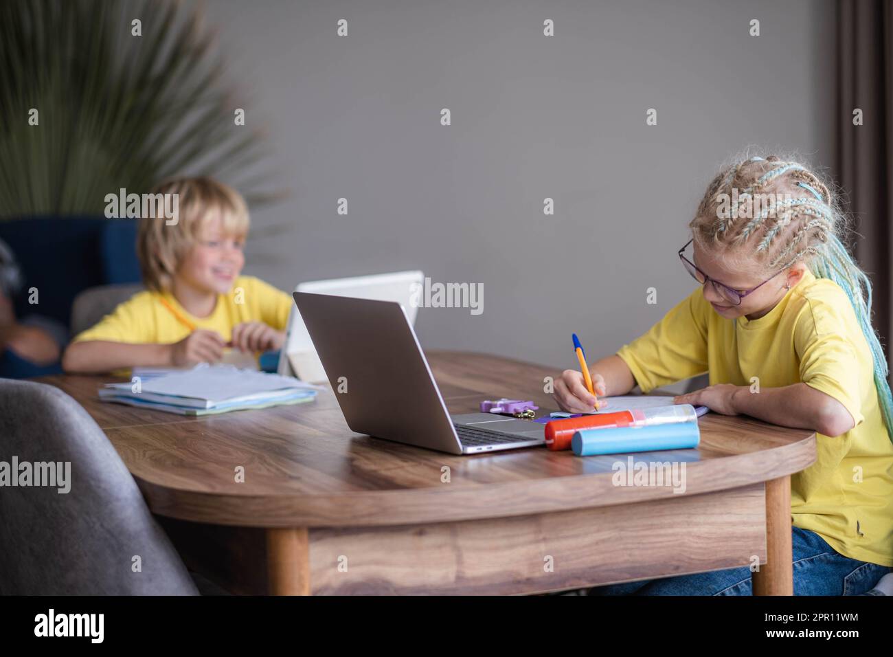 Distance learning online education, boy and girl studying at home with ...