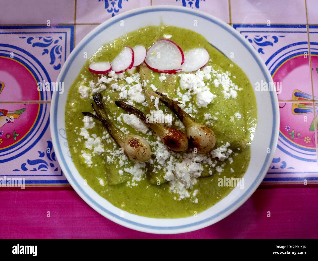 Typical Mexican dish, green enchiladas made with tortillas browned in