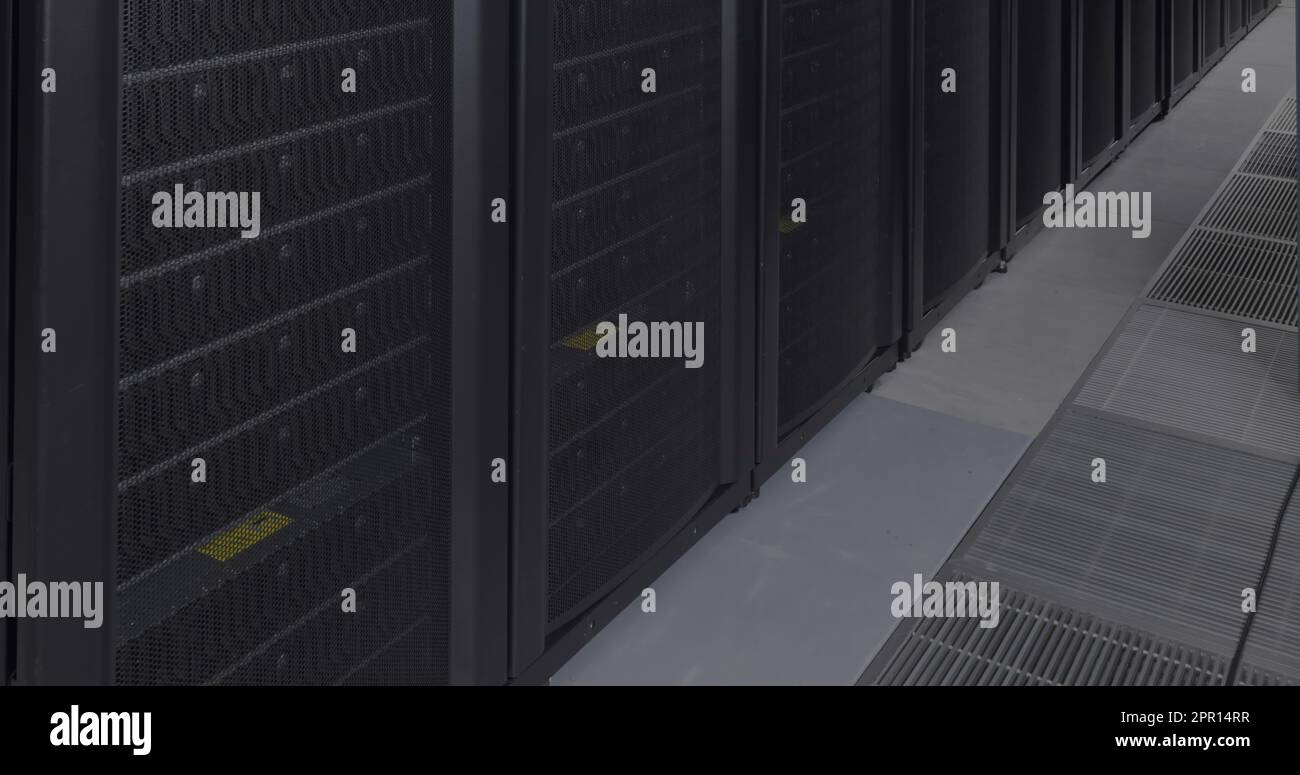 General view of empty server room with multiple black servers Stock Photo