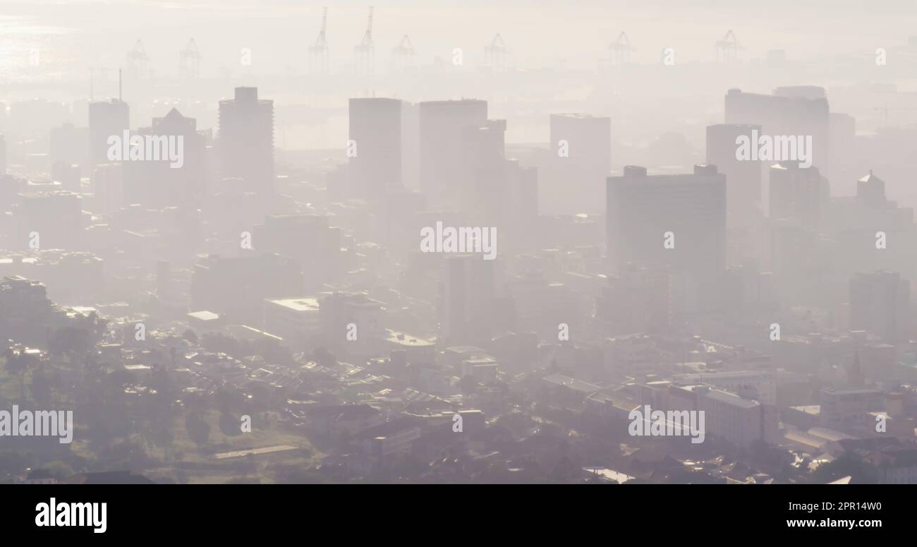 General view of misty modern cityscape with skyscrapers and building site Stock Photo
