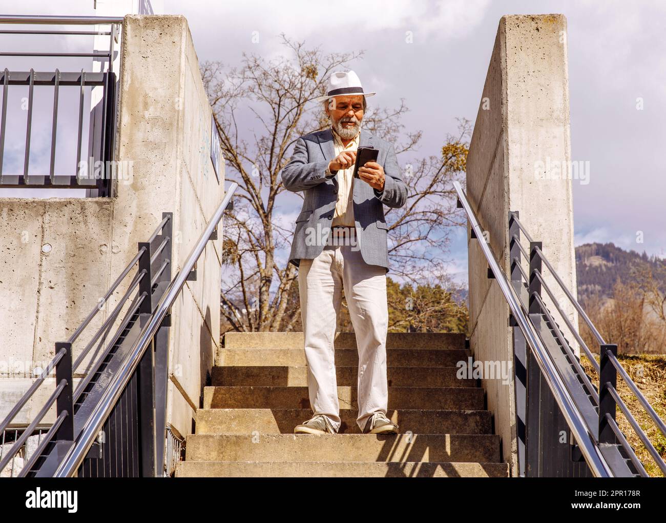 Portrait of a confident, handsome, mature man, pensioner, grandfather in the small town Stock Photo