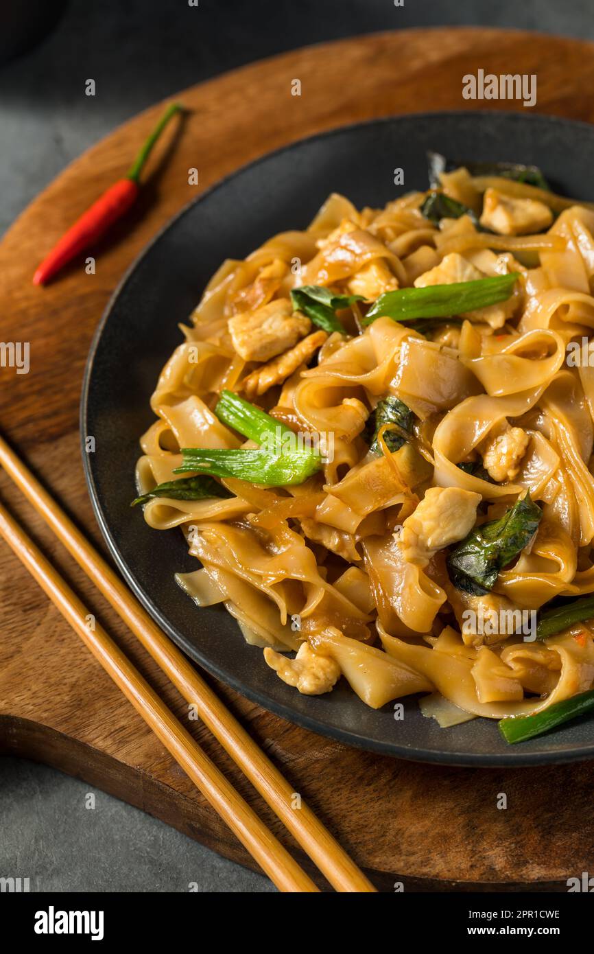 Spicy Homemade Thai Drunken Noodles with Chicken and Basil Stock Photo