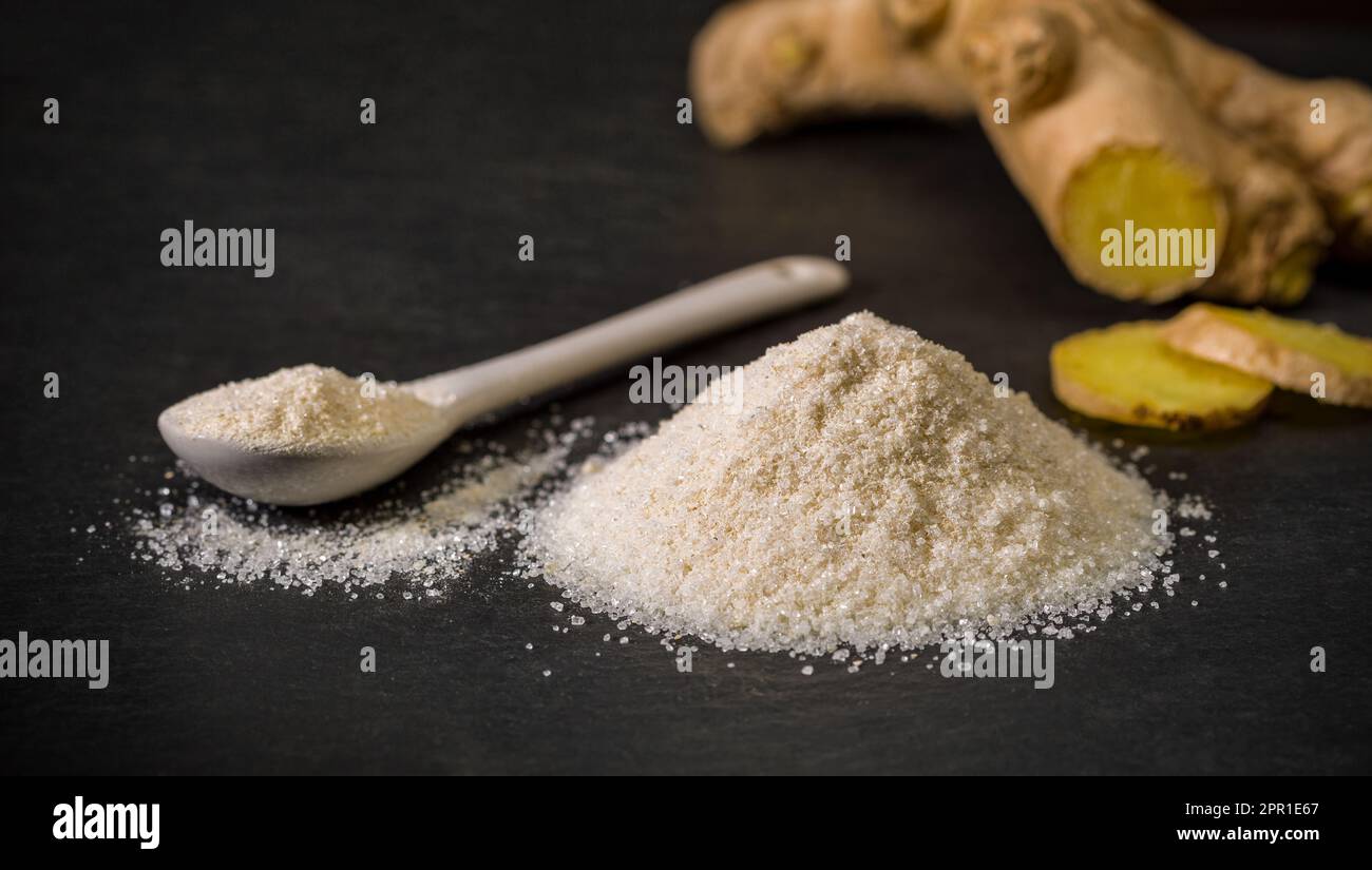 Ginger sugar. Spoon and a pile of sugar, salt or flour. Spices for recipes. Sweets. Ground spice. Stock Photo