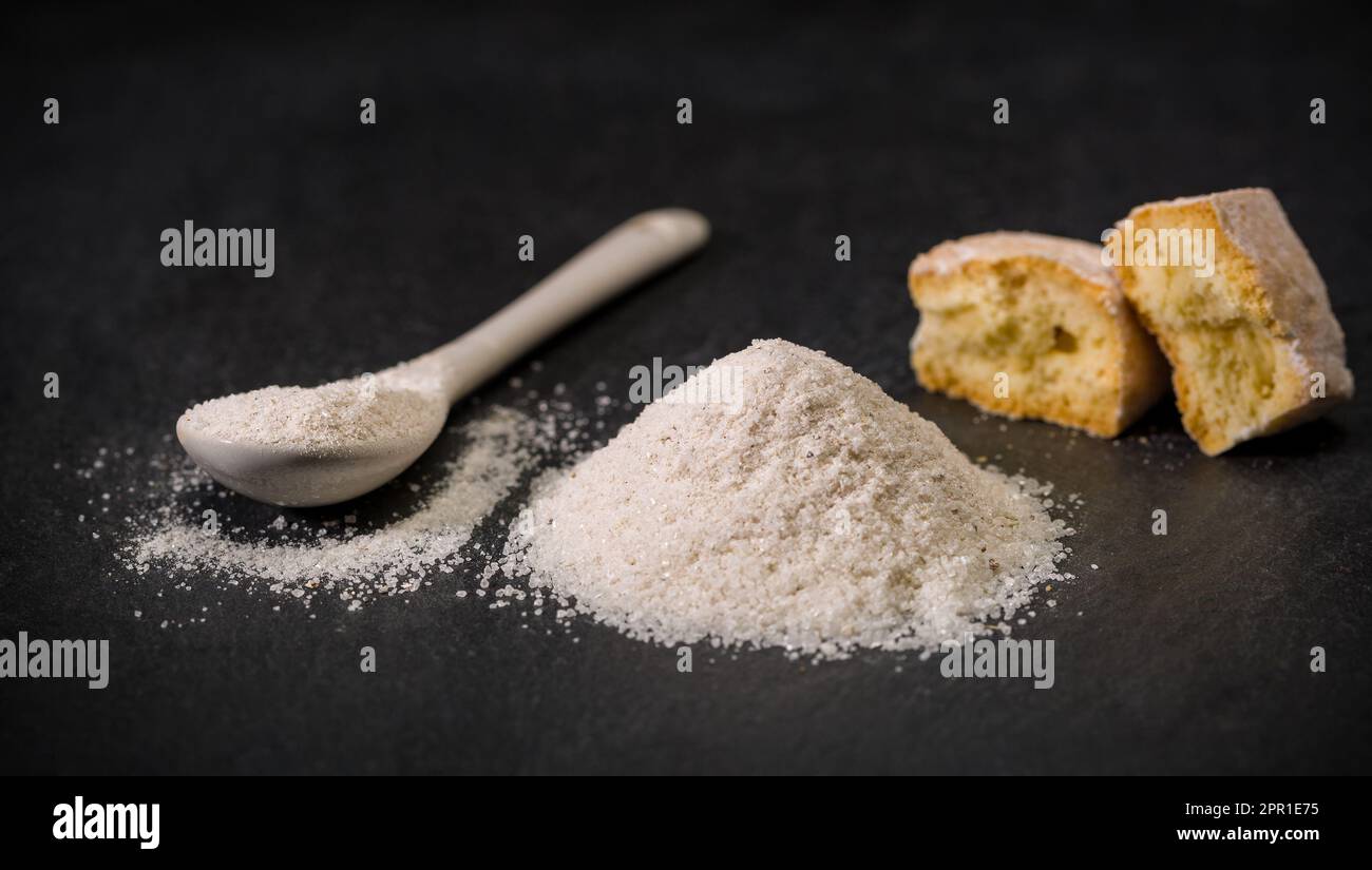 Spices for recipes. Milanese sugar. Spoon and pile of sugar, cookie or biscuit. Sweets. Ground spice Stock Photo