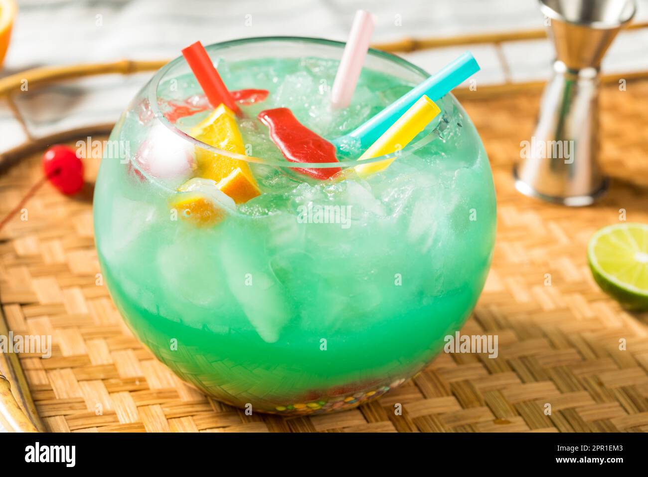 Boozy Cold Blue Tiki Fishbowl Cocktail with Orange and Rum Stock Photo