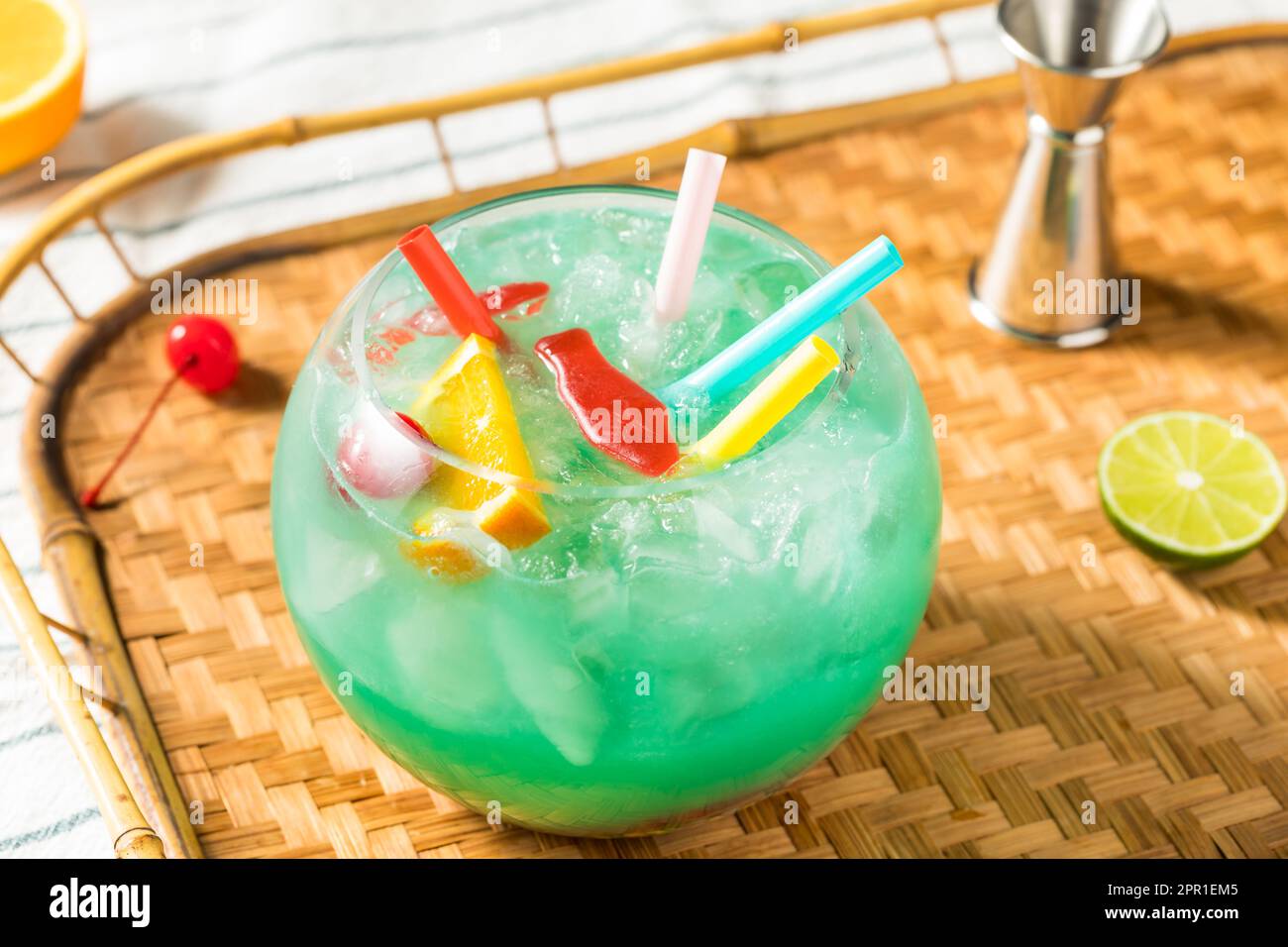 Boozy Cold Blue Tiki Fishbowl Cocktail with Orange and Rum Stock Photo
