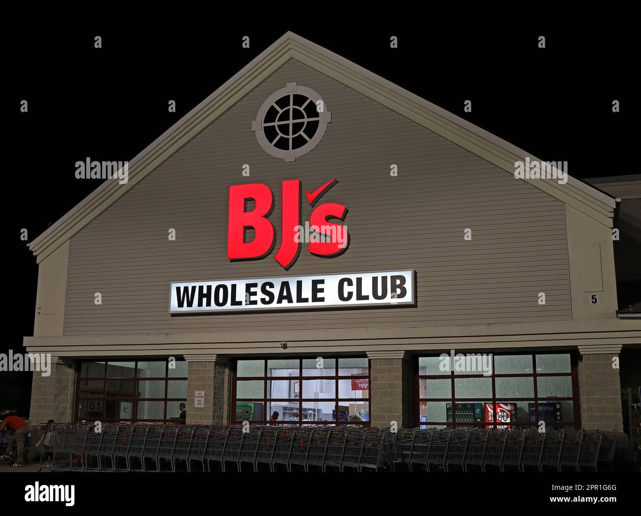 BJ's Wholesale Club members only retailer storefront, night USA Stock
