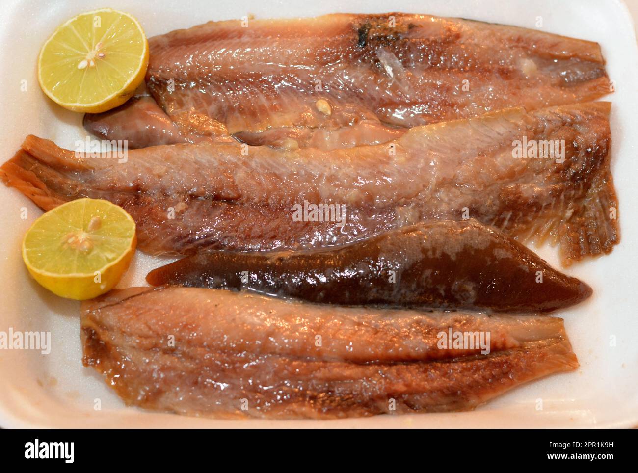 Pieces of hot smoked herring fish fillets and soft roe prepared with