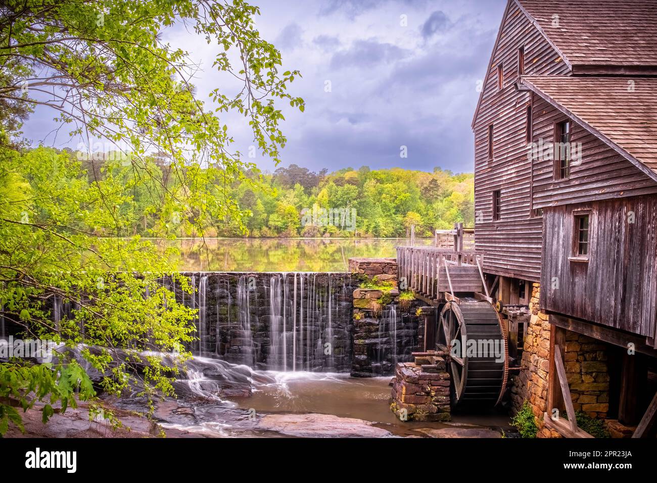 Landscape view of the millpond, waterfall, and gristmill at Historic
