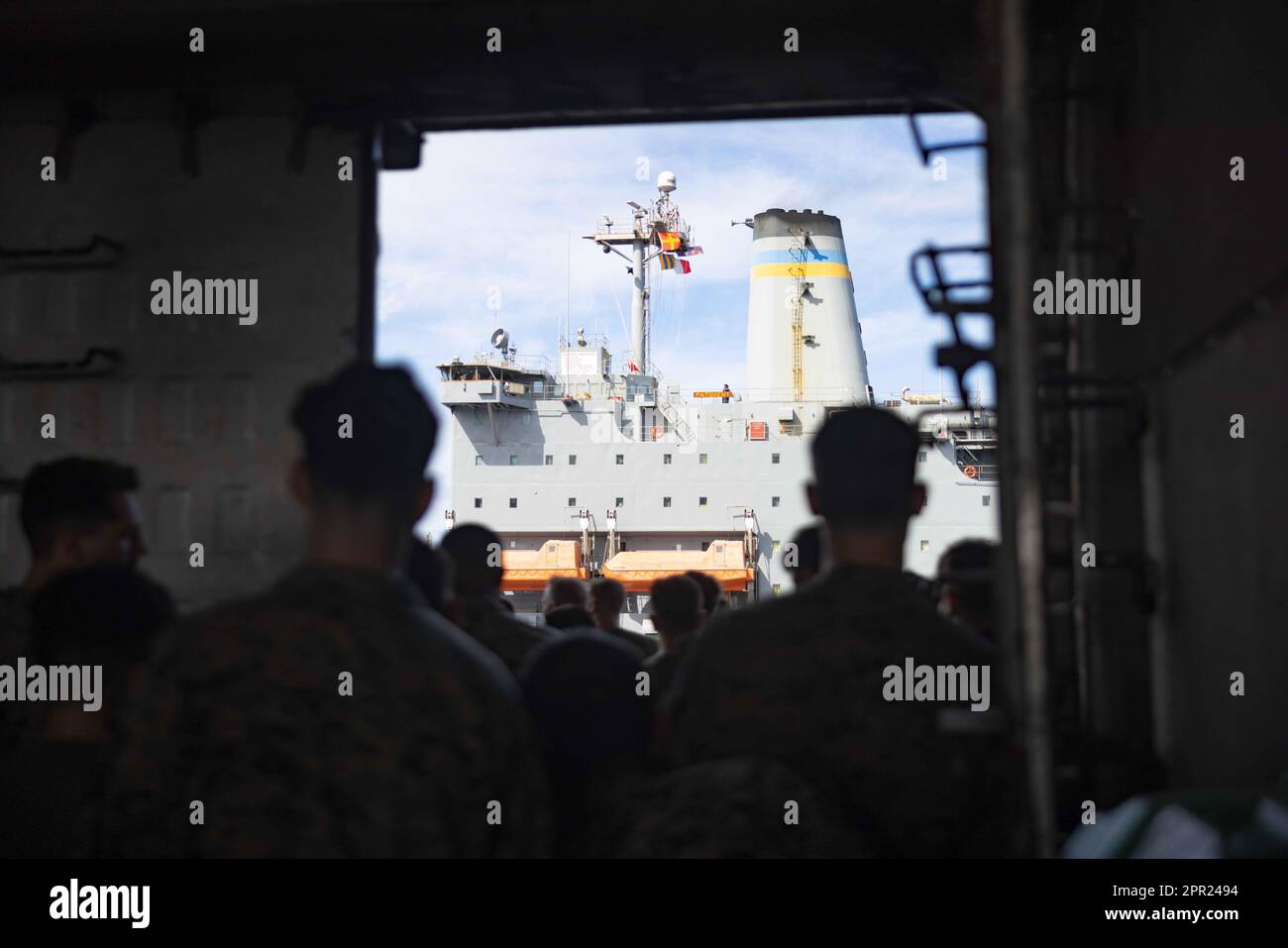 U.S. Marines and Sailors with the 26th Marine Expeditionary Unit (MEU) and the USS Bataan (LHD 5) prepare for a Resupply At-Sea (RAS) during Amphibious Ready Group/MEU Exercise, Atlantic Ocean, April 22, 2023. The RAS was supported by the USNS Patuxent (T-AO-201), transferring fuel, munitions and supplies to the USS Bataan (LHD 5) while under way. The 26th Marine Expeditionary Unit is underway with the Bataan ARG as part of it’s Pre-deployment Training Program. (U.S. Marine Corps photo by Cpl. Kyle Jia) Stock Photo