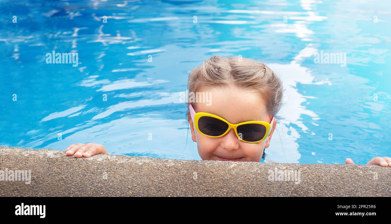 Child in sunglasses in the pool portrait Stock Photo Alamy