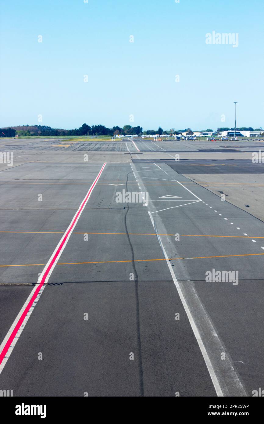 The Runway at Christchurch International Airport, New Zealand, as viewed from inside an airplane sitting on the tarmac. Stock Photo