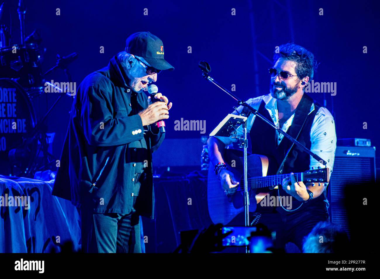 Caballeros de la Quema rock band and León Gieco during a live show at Luna Park Stadium, Buenos Aires, Argentina. Stock Photo