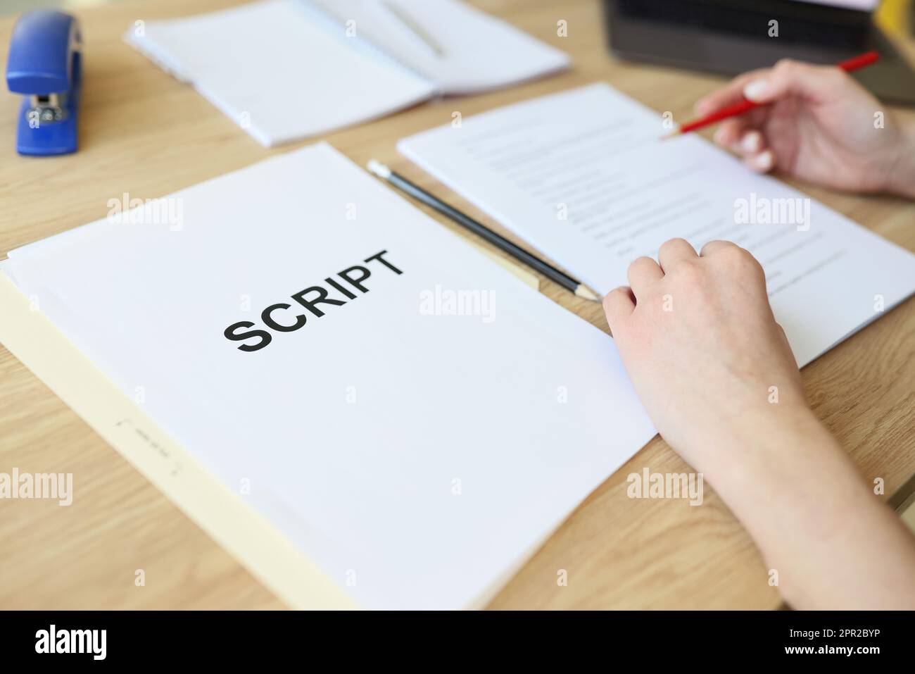 Attentive woman reads script papers editing text with pencil Stock ...