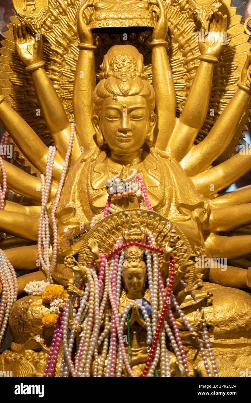 Golden statue of  Quan Yin 'Goddess of Mercy' in Buddhist temple, Thailand Stock Photo