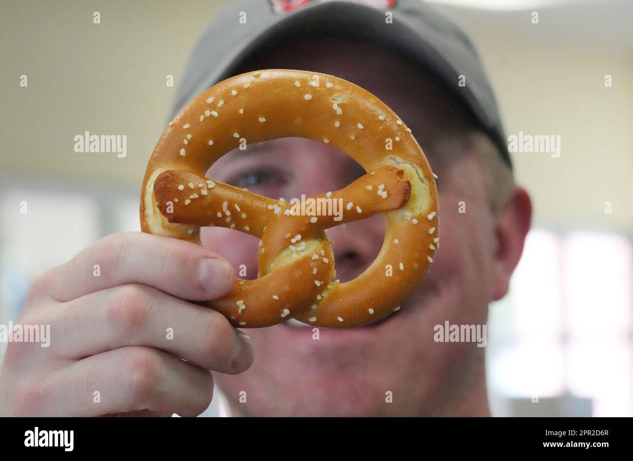 St. Louis, United States. 25th Apr, 2023. Gus Koebbe Jr. checks the shape of a twisty pretzel at