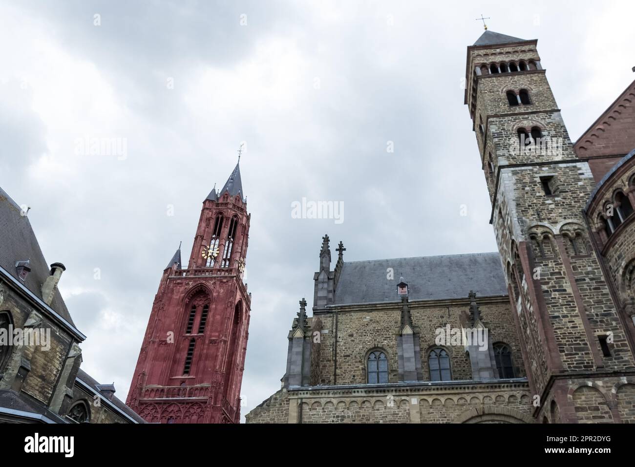 Iconic buildings in the city of Maastricht, Netherlands - the Gothic Church of Saint John (red tower) and the stunning Basilica of Saint Servatius Stock Photo