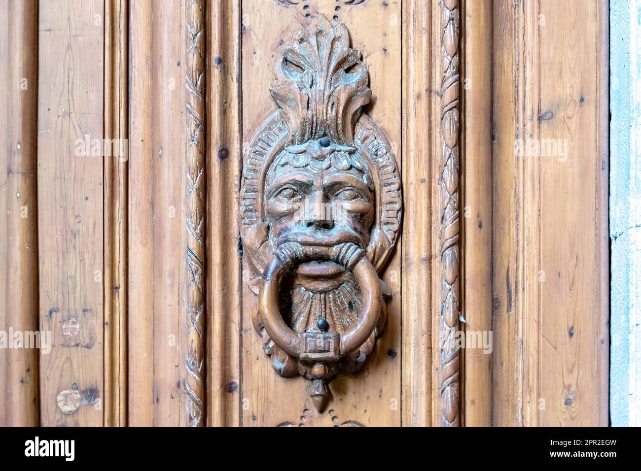 Intricate details of an ancient door knob on a gate in the Gothic Quarter, the historic heart of Barcelona's old city. Stock Photo