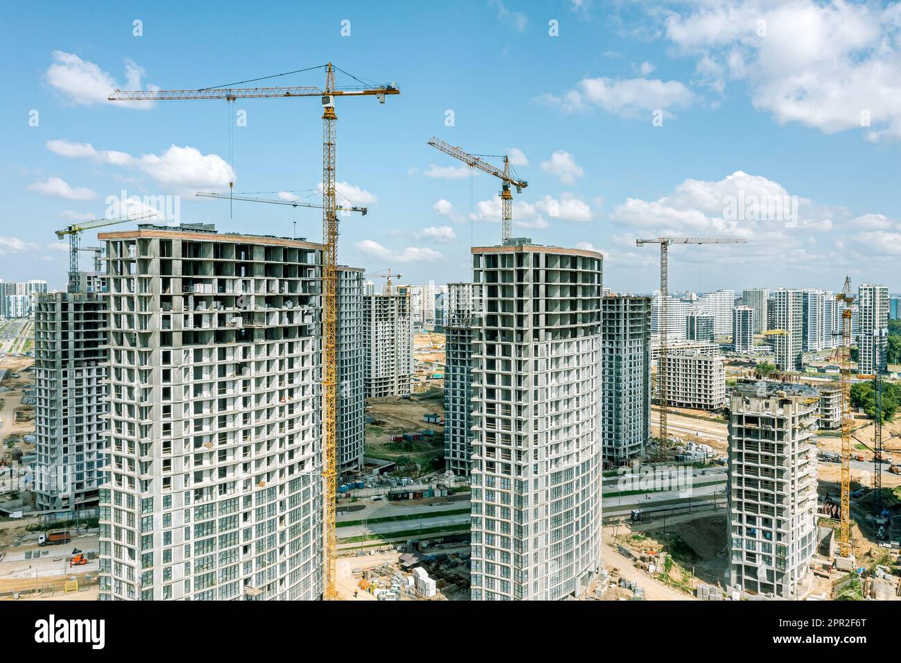 new multistory apartment buildings under construction with cranes on ...