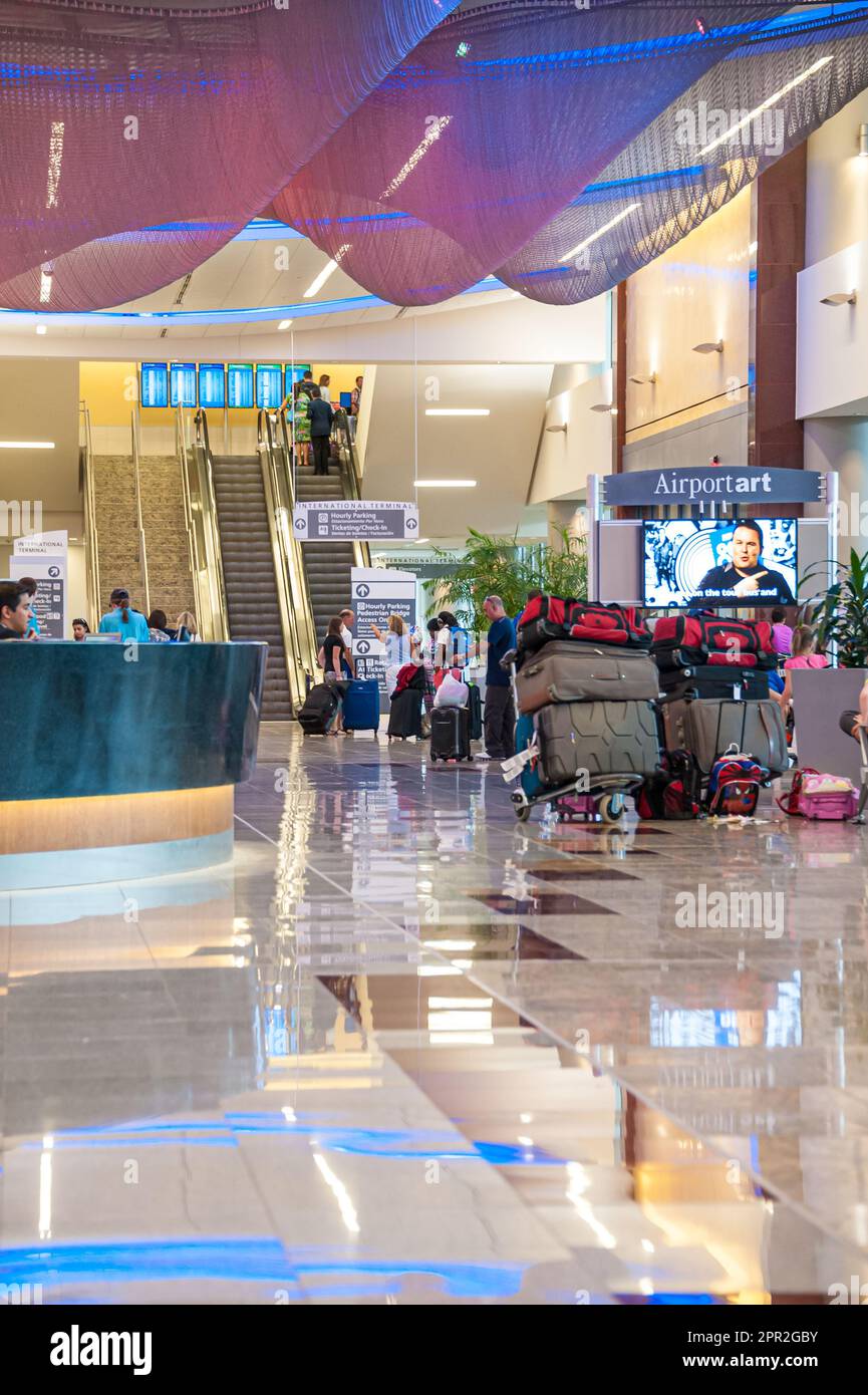 Families and friends gathered with luggage inside the International Terminal at Hartsfield