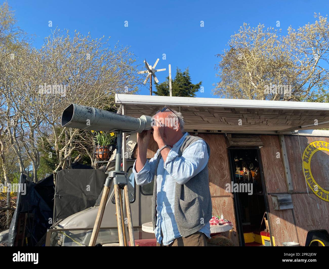 Dores, UK. 21st Apr, 2023. 'Nessie hunter' Steve Feltham looks through a telescope at Loch Ness. For decades, Steve Feltham has been observing the legendary lake in the Scottish Highlands. It is obvious who plays the leading role around Loch Ness: the legend of the lake monster has fired people's imagination for decades. But is Nessie really in the famous lake? (to dpa 'Really a monster? Loch Ness does not reveal its mystery') Credit: Benedikt von Imhoff/dpa/Alamy Live News Stock Photo