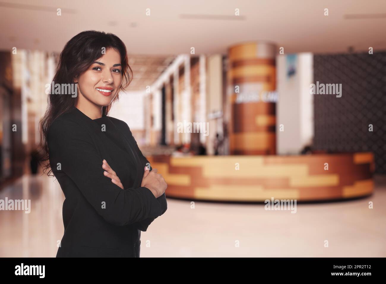 Portrait of hostess wearing uniform in shopping mall. Space for text Stock Photo
