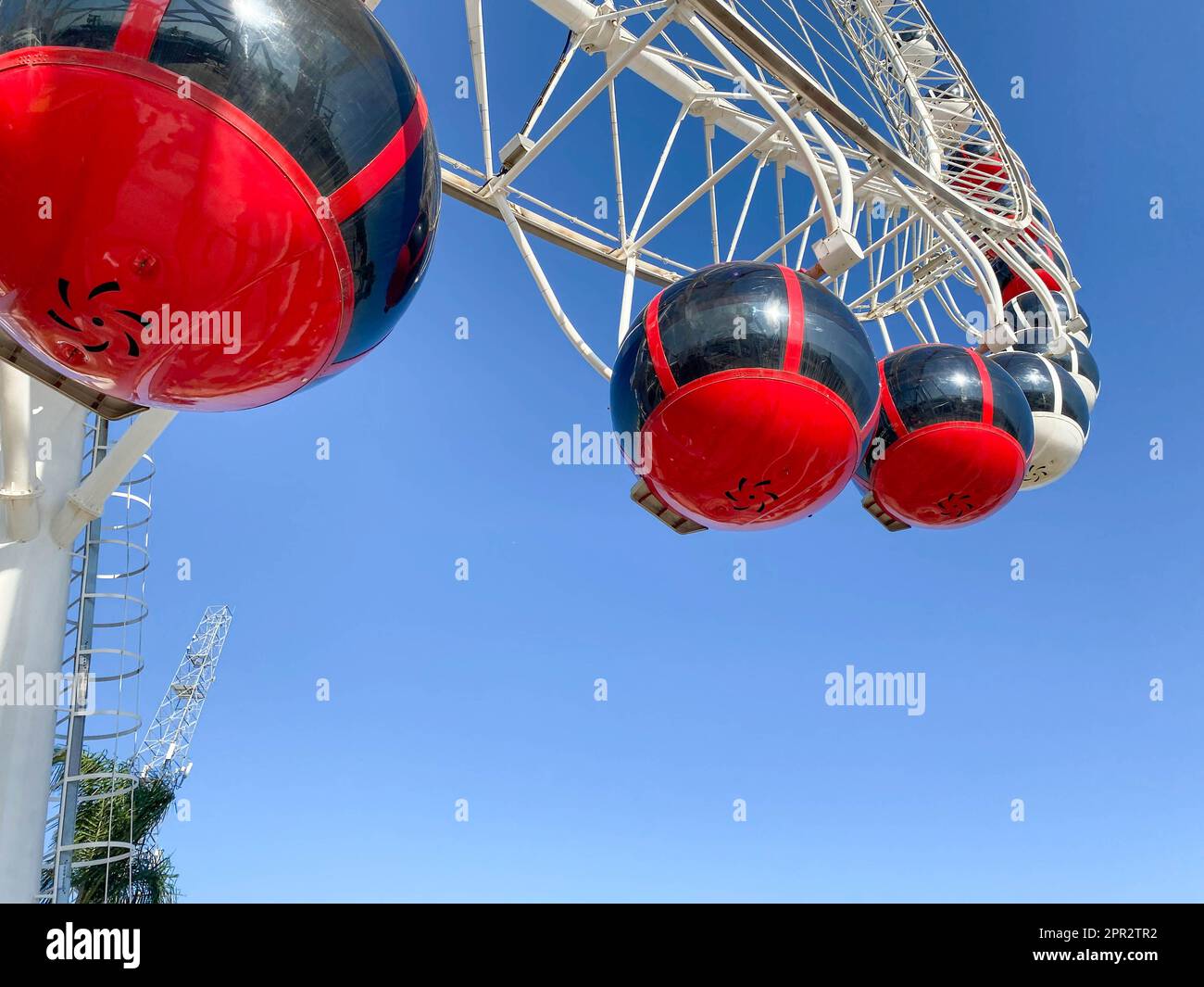 Cabins Ferris wheel against a blue sky with clouds Stock Photo - Alamy