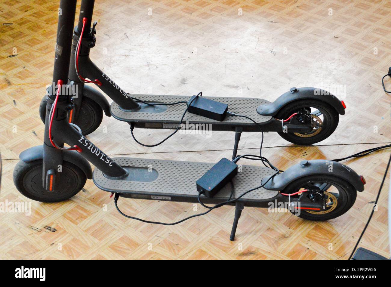 Two new black electronic two-wheeled fashionable modern fast electric scooters. Stock Photo