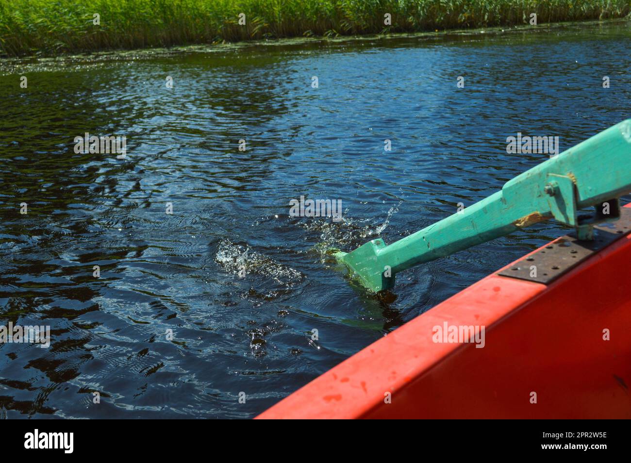 Wooden oars for the boat lowered into the water on a rest walk on the water of the lake the river the sea on the nature. Stock Photo