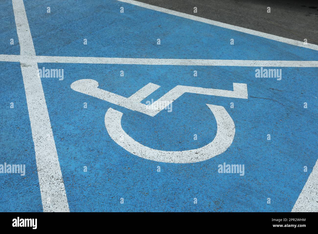 Wheelchair symbol on asphalt road. Disabled parking permit Stock Photo Alamy