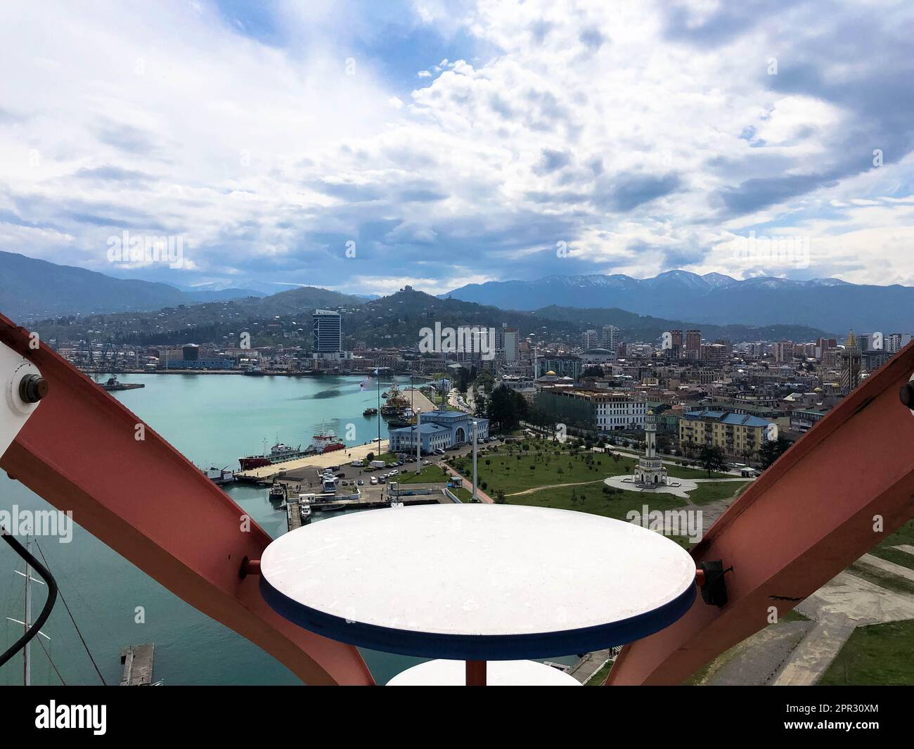 Top view from the cabin of a ferris wheel over the city with houses ...