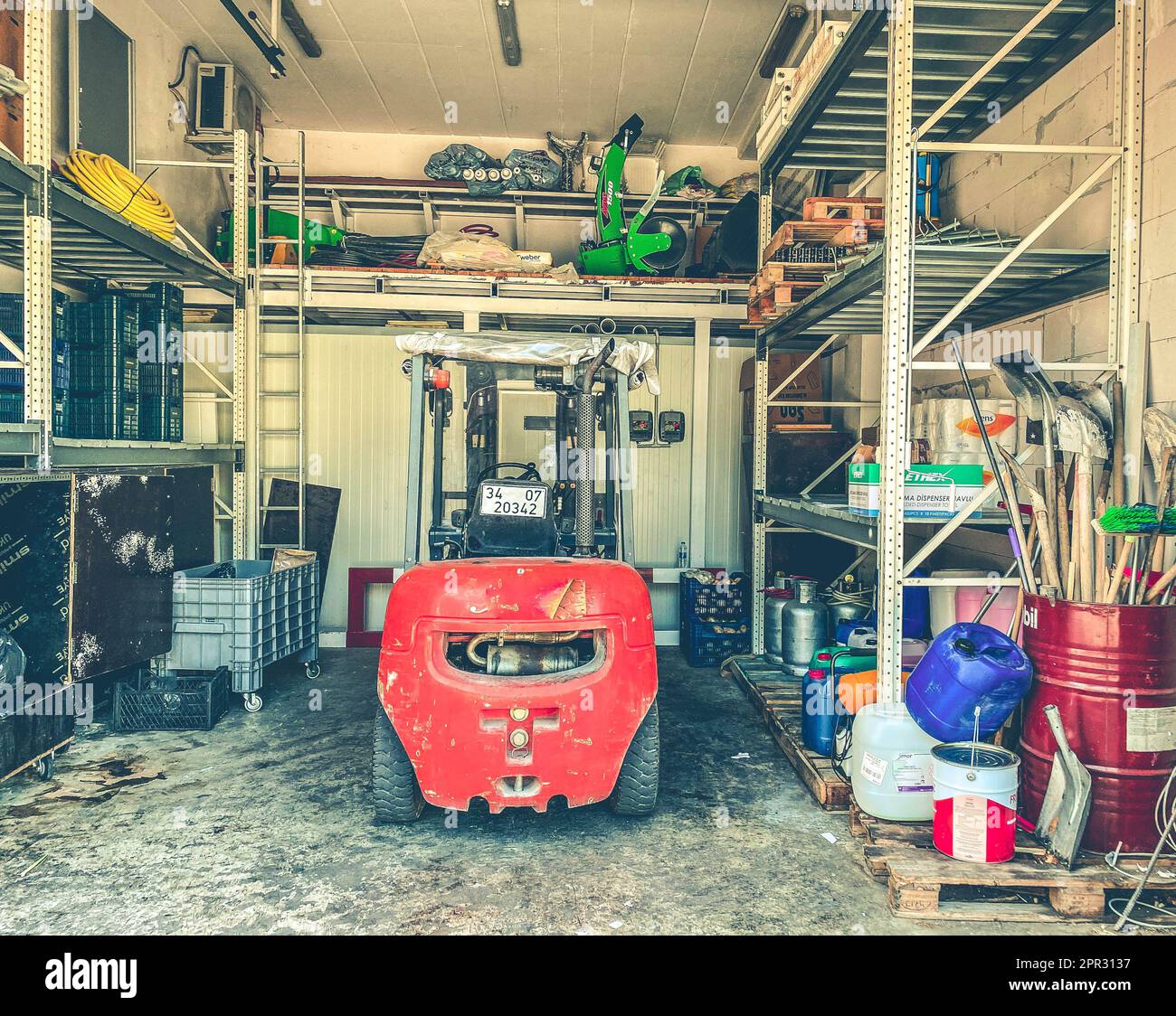 a red tractor stands in the garage. home and garden equipment, garden